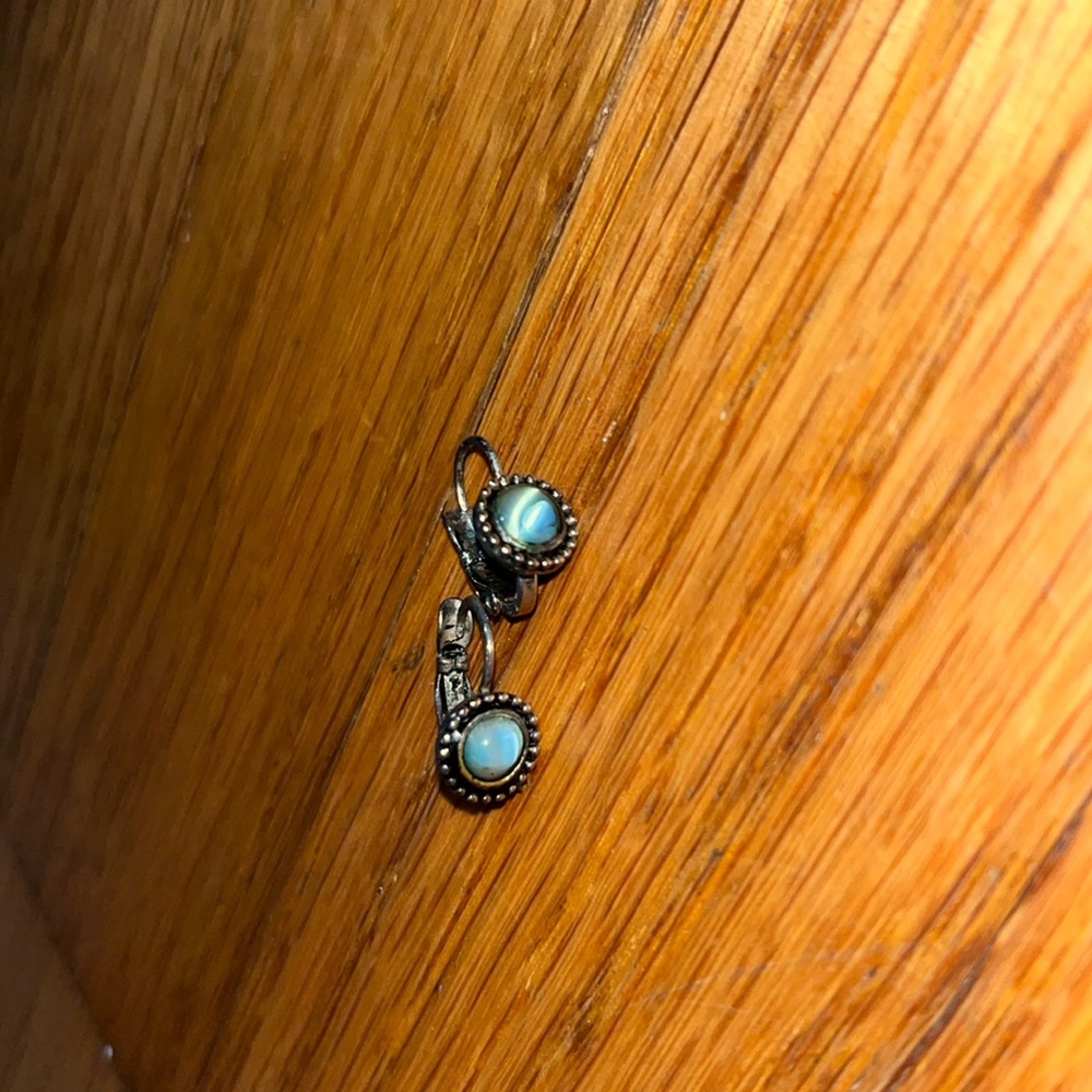 Small drop earring it’s round with a little bit of blue in the middle